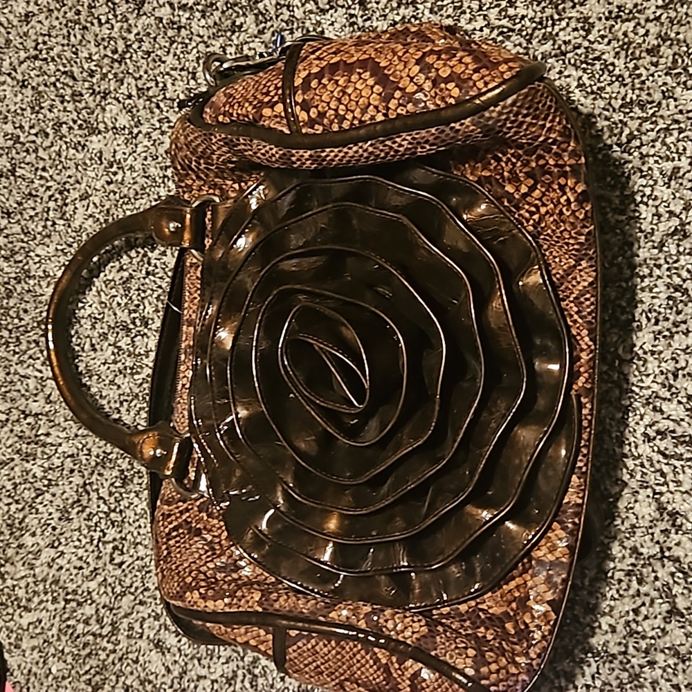 M.C. brown purse with rose on the front. Good for dressing up or down.